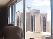 Interracial couple fucking in front of the window