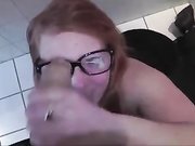 Cute redhead gives a quick oral sex in bathroom at work
