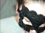 Masked female partner with green eyes sucking dick and getting a facial
